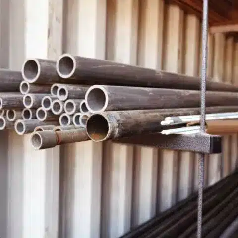 Pipe rack holding steel pipe inside a SiteBox