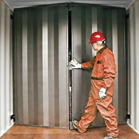 Worker opening a SiteBox interior wall divider