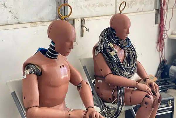 Crash test dummies seated inside a test building