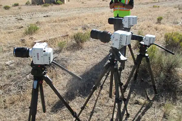High-speed cameras on tripods at the blast test site