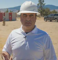 Dr. Ali Sari in a hard hat at a facility site
